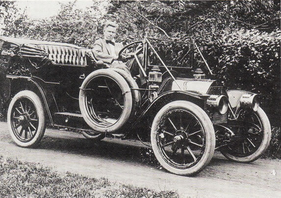 Black and white photo of early Ford model car